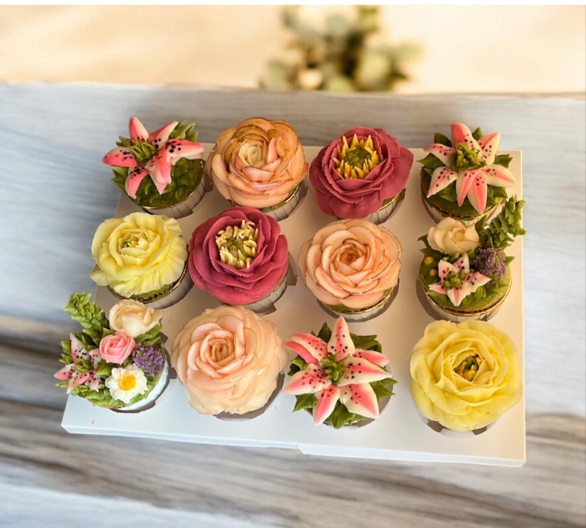 Trina holding buttercream floral cupcakes from a luxury home bakery in Iowa